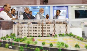The Prime Minister, Shri Narendra Modi visiting an exhibition on Flagship Missions of Urban Development during the event Transforming Urban Landscape: Third Anniversary of Pradhan Mantri Awas Yojana (Urban), Atal Mission for Rejuvenation of Urban Transformation (AMRUT) and the Smart Cities Mission, in Lucknow, Uttar Pradesh on July 28, 2018. The Union Home Minister, Shri Rajnath Singh, the Chief Minister of Uttar Pradesh, Yogi Adityanath and the Secretary, Ministry of Housing and Urban Affairs, Shri Durga Shanker Mishra are also seen.